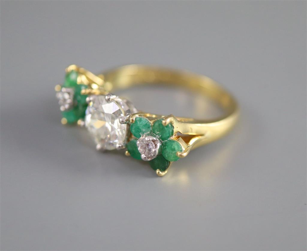 A modern 18k emerald and diamond set dress ring,